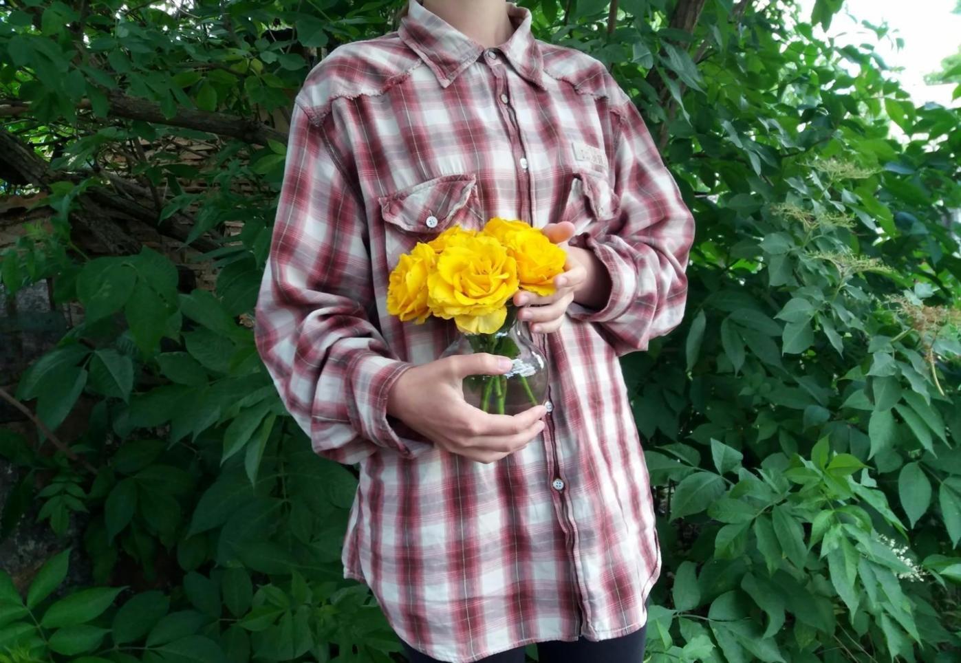 Professional florist carefully selecting fresh flowers for a custom bouquet arrangement